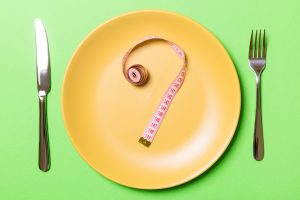 Question mark made of measuring tape on round plate
