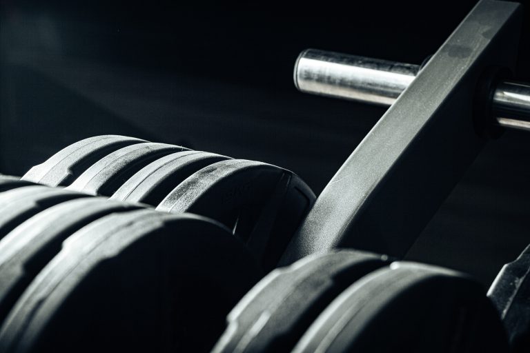 Gym weight plates on holder close up