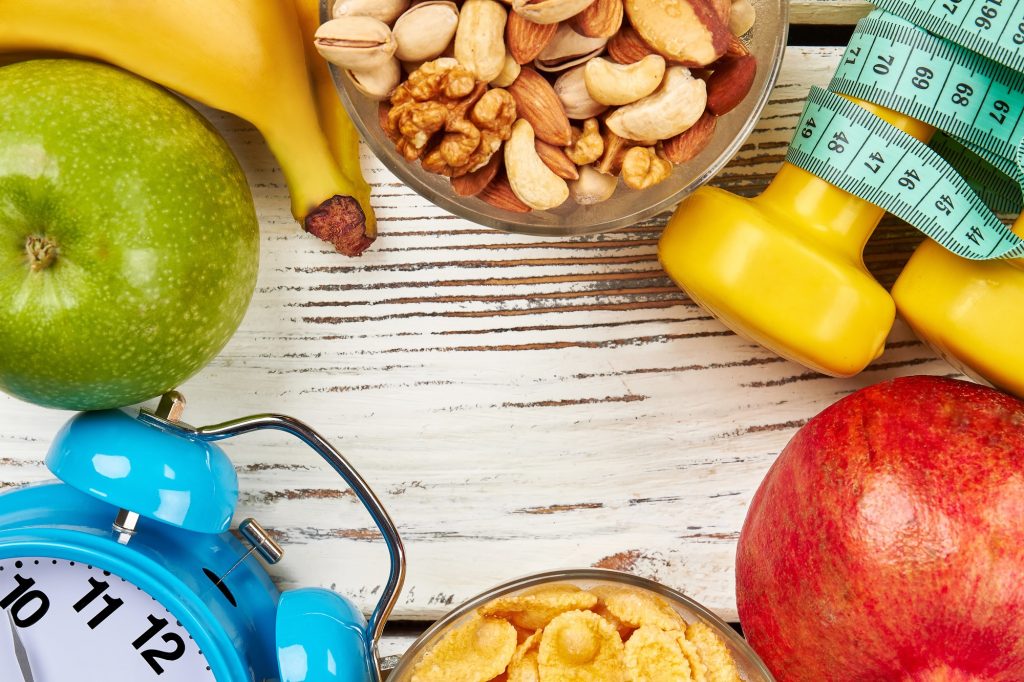 Alarm clock, fruits and nuts