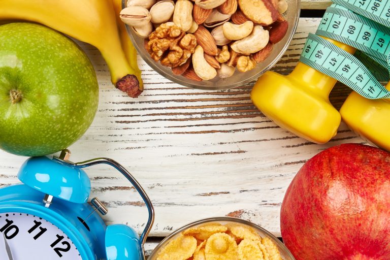 Alarm clock, fruits and nuts