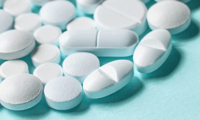 white pills on blue background